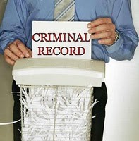 criminal record being shredded by a guy in a blue shirt and tie